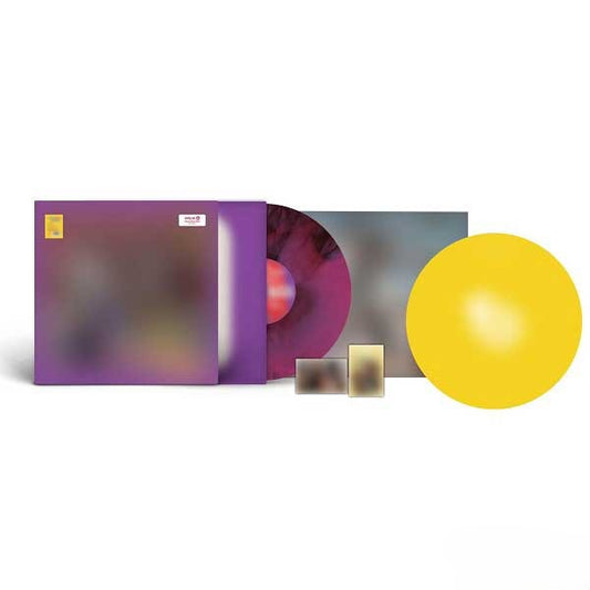 Vinyl record set with a purple cover, yellow disc, and additional packaging on a white background